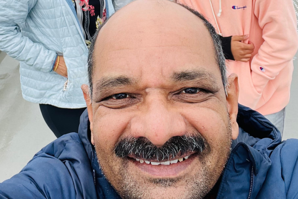 Anilkumar with his family behind him