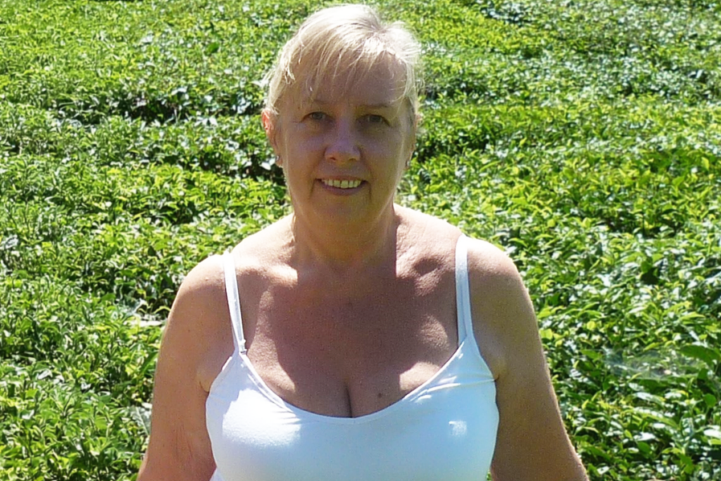 Linda with a lush green background