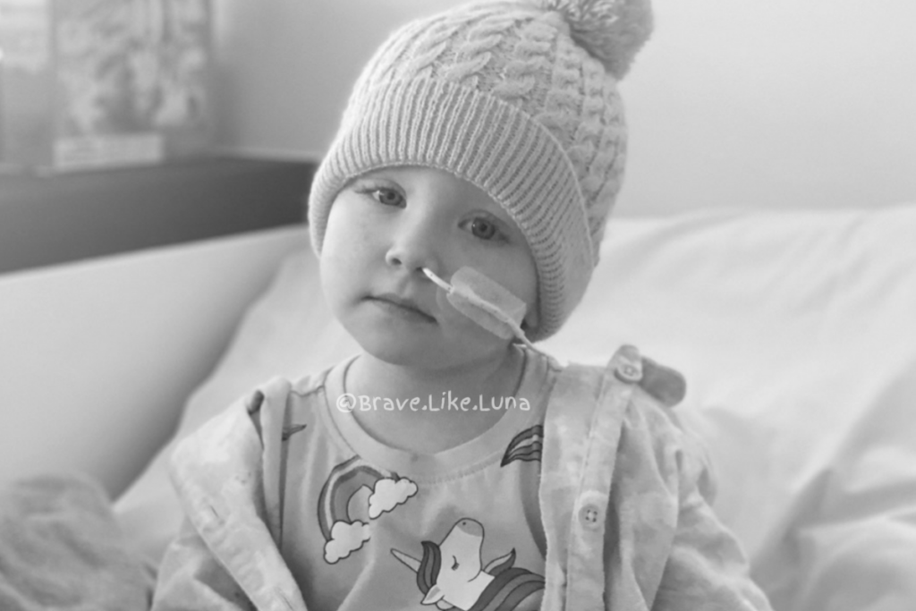 Black-and-white photo of Luna with a feeding tube