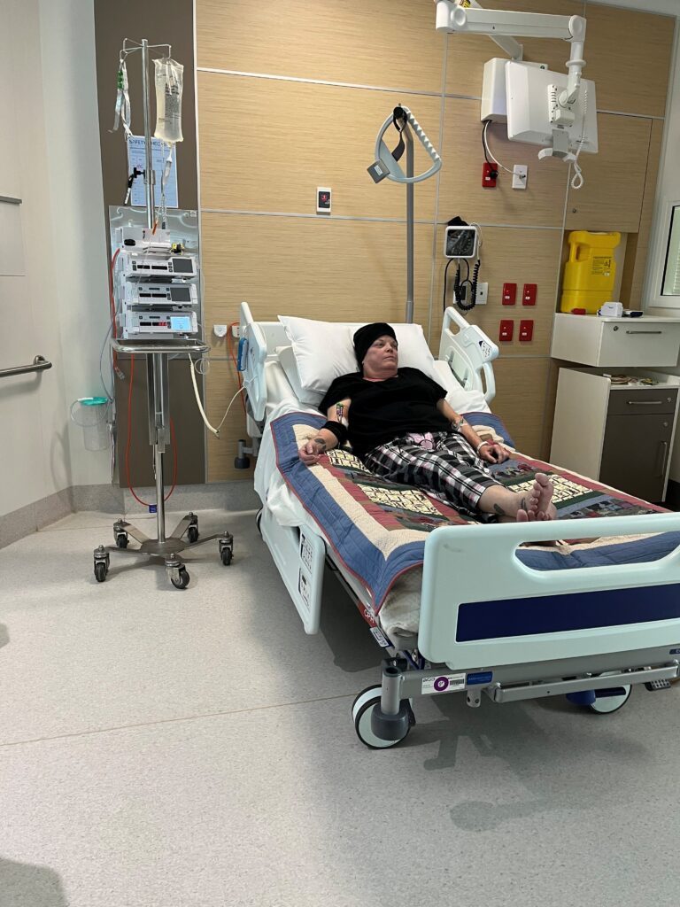 Karen sitting in a hospital bed