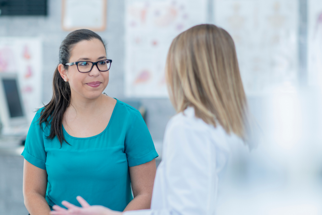 Female having conversation with health professional in white coat